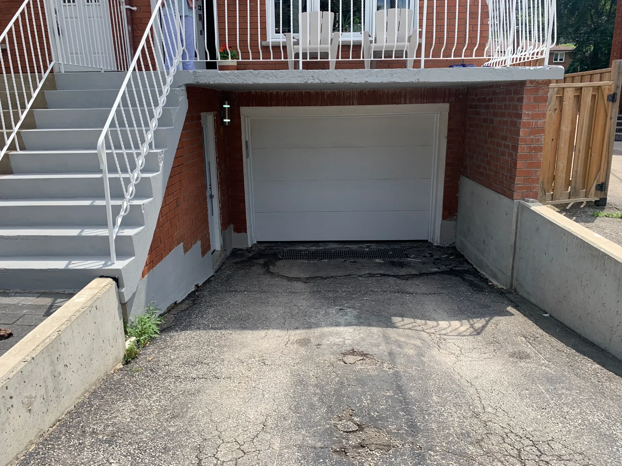 Below-grade driveway leading to a garage opening