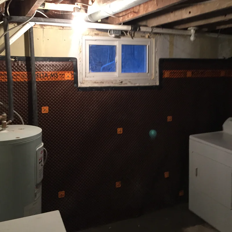 Interior basement waterproofing membrane on wall