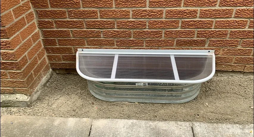 Window-well cover protecting a basement opening